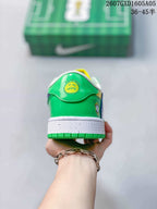 Rear view of the sneaker showing green heel panels, a white midsole and green outsole.