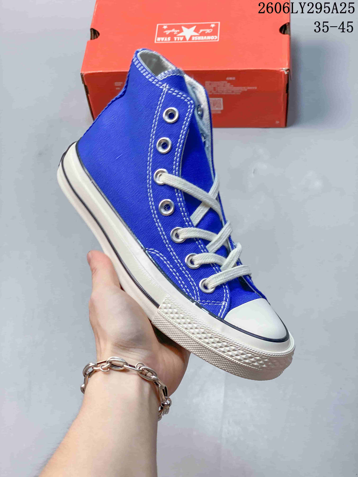 Blue high-top sneaker with white laces, metal eyelets, and a white rubber toe cap; size range 35–45 is printed in the image.