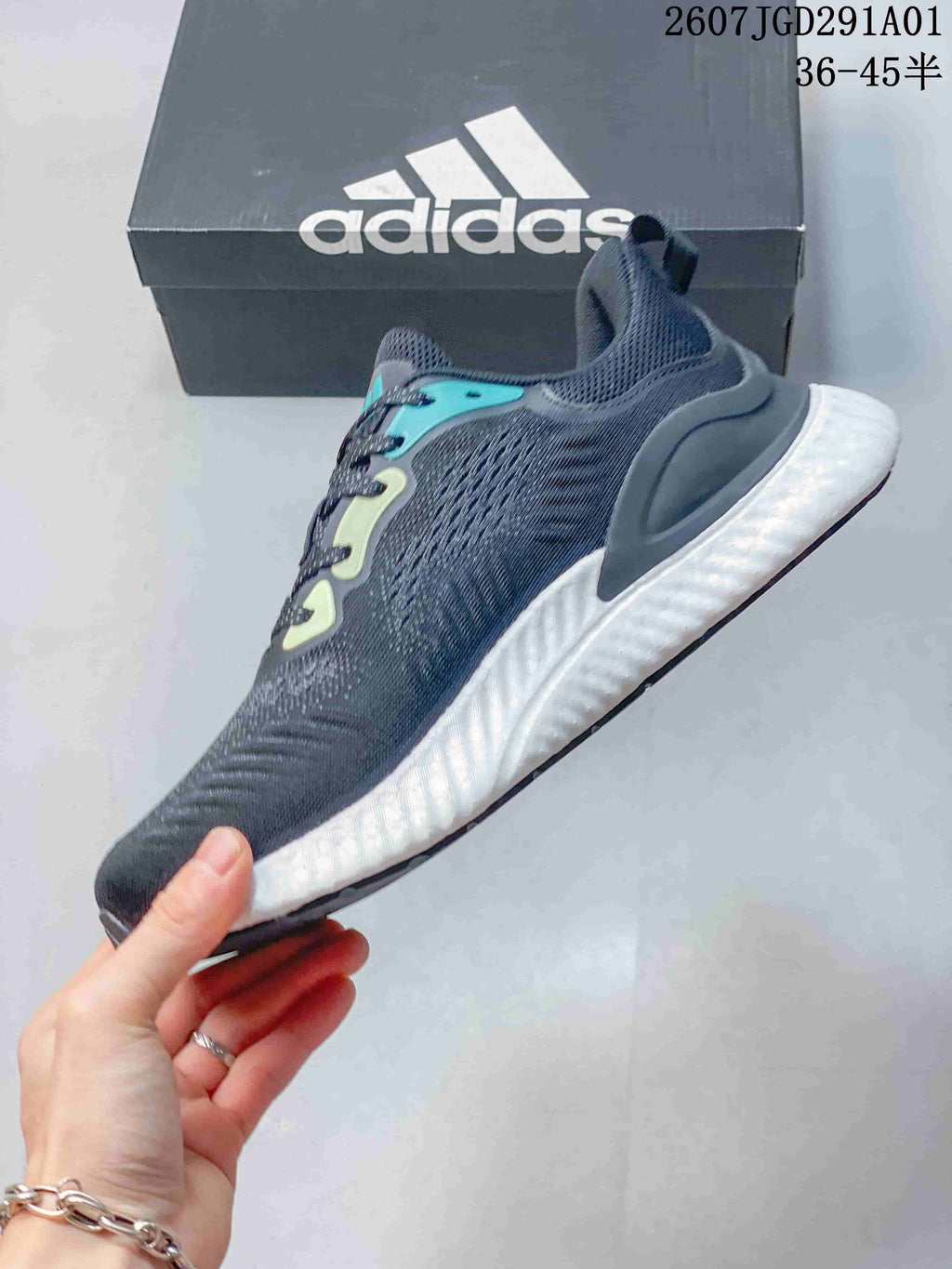 Side view of the navy sneaker with teal accents and a white midsole.