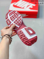 Close view of the red-and-white patterned outsole on the Nike sneakers.