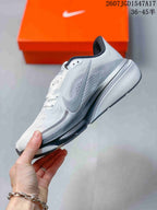 Side view of a white and gray Nike Pegasus 42 running shoe showing the swoosh, perforated upper panels, layered midsole, and black outsole.