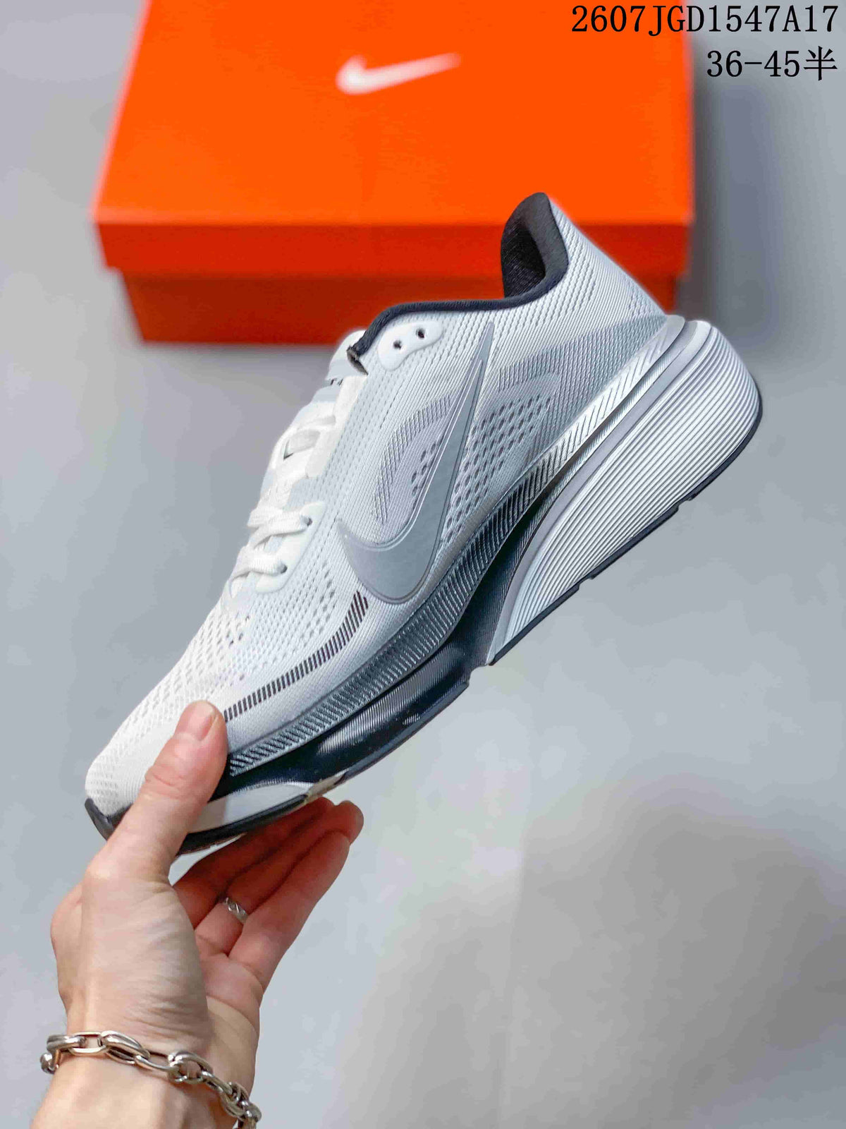 Side view of a white and gray Nike Pegasus 42 running shoe showing the swoosh, perforated upper panels, layered midsole, and black outsole.