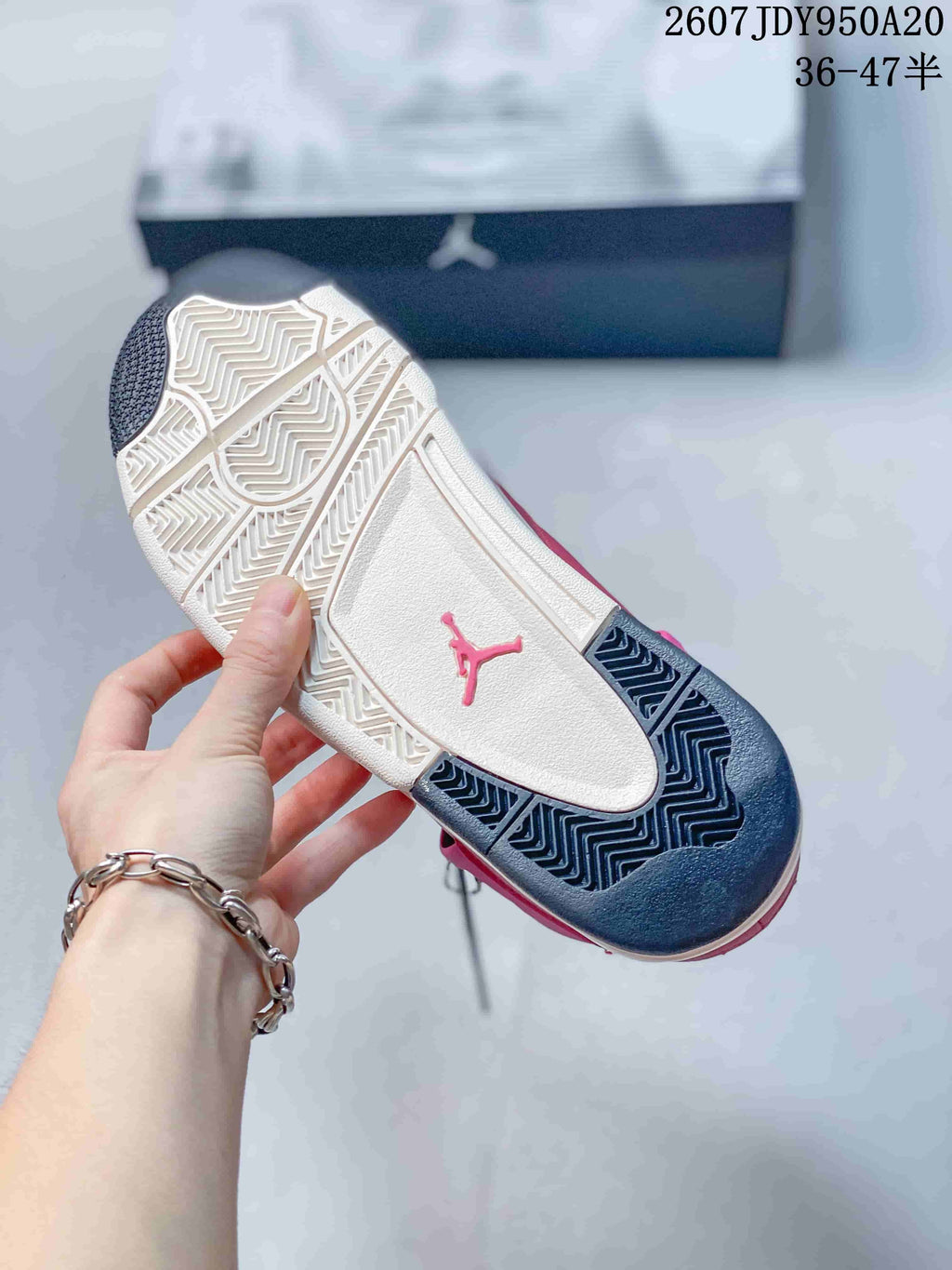 Outsole view showing the contrasting pink, white, and black patterned rubber sections and a pink Jumpman mark.