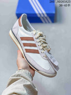 Angled side view showing the low-profile silhouette, textured white overlays and brown stripes.