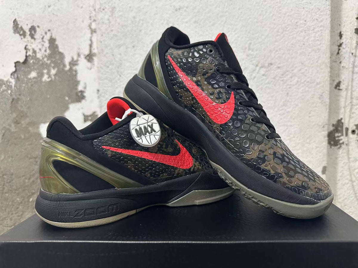 Two Nike Kobe shoes displayed together, showing the red Swoosh and camouflage-patterned upper.