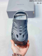Top view of a dark gray clog showing the closed toe, ventilation openings, and textured footbed.