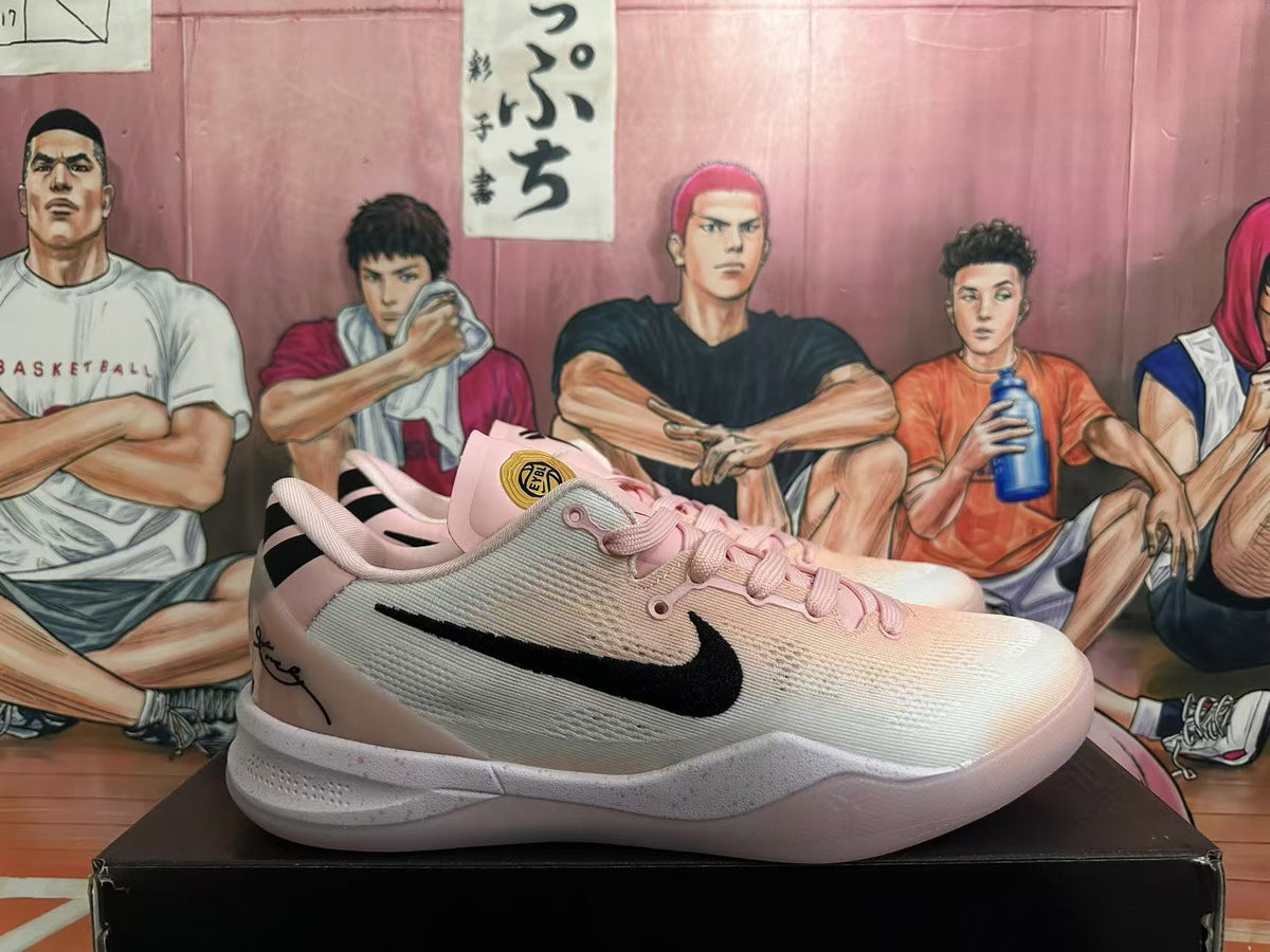 Side view of a pink Nike sneaker showing the black Swoosh, pale upper and white sole.