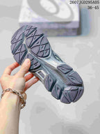 Close-up of the segmented charcoal outsole showing its patterned tread and midsole structure.