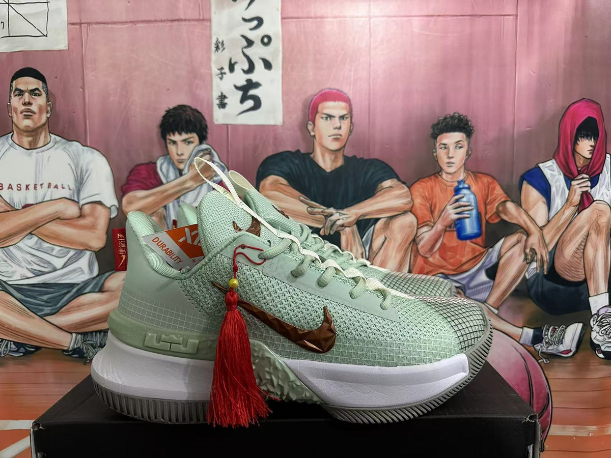 Side view of a jade green Nike sneaker with bronze-toned Swoosh detailing, white midsole, textured outsole, and red tassel accessory.