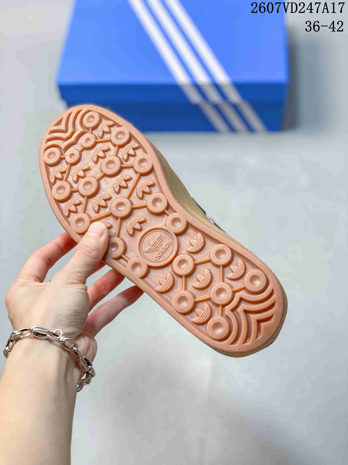 Close-up of the gum-colored outsole showing circular and trefoil-patterned tread details.