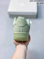Rear view of the pale green sneaker showing the Nike Air heel tab and textured outsole edge.