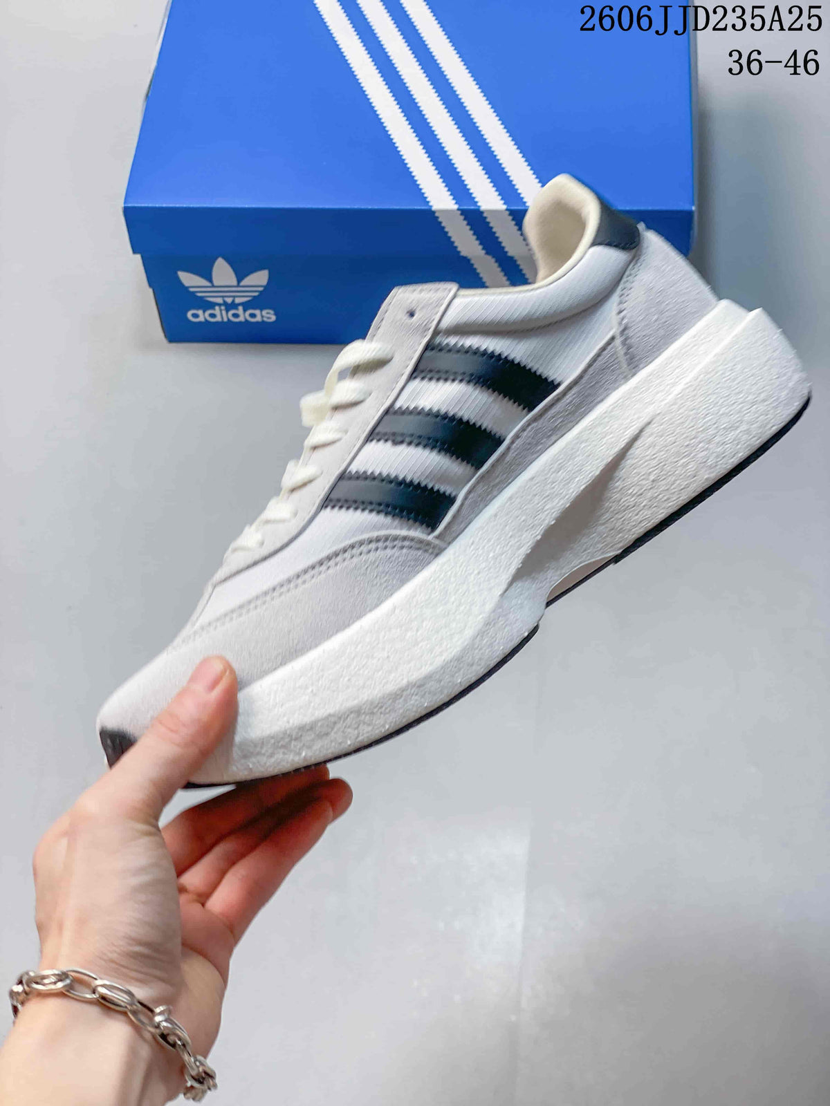 Side profile showing the white upper, black three-stripe detail, lace-up construction, and raised midsole.