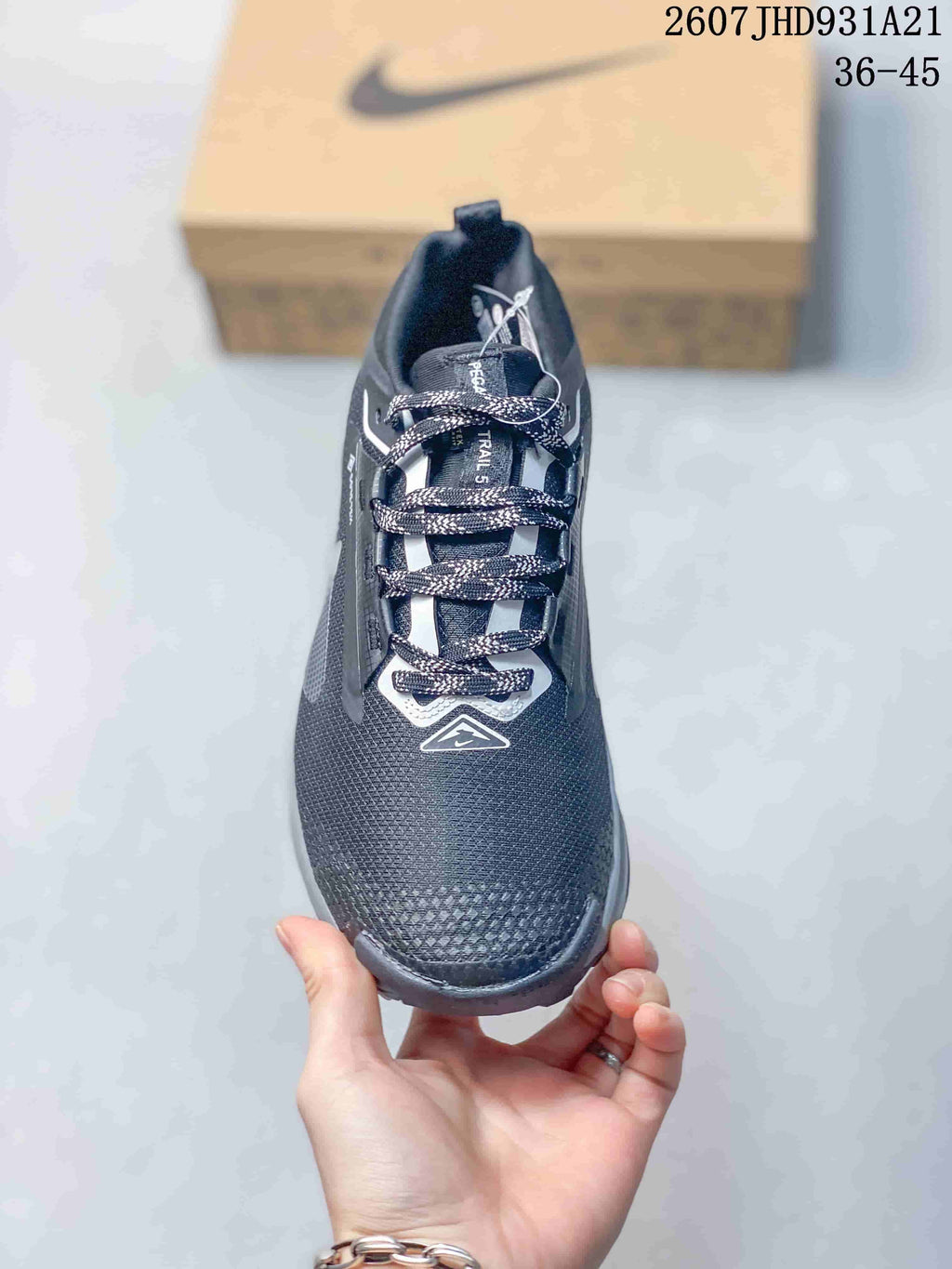 Top view of the sneaker showing the patterned laces, tongue, white lace details, and textured toe box.