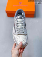 Top view showing the perforated white toe box, braided gray laces, and Nike tongue label.