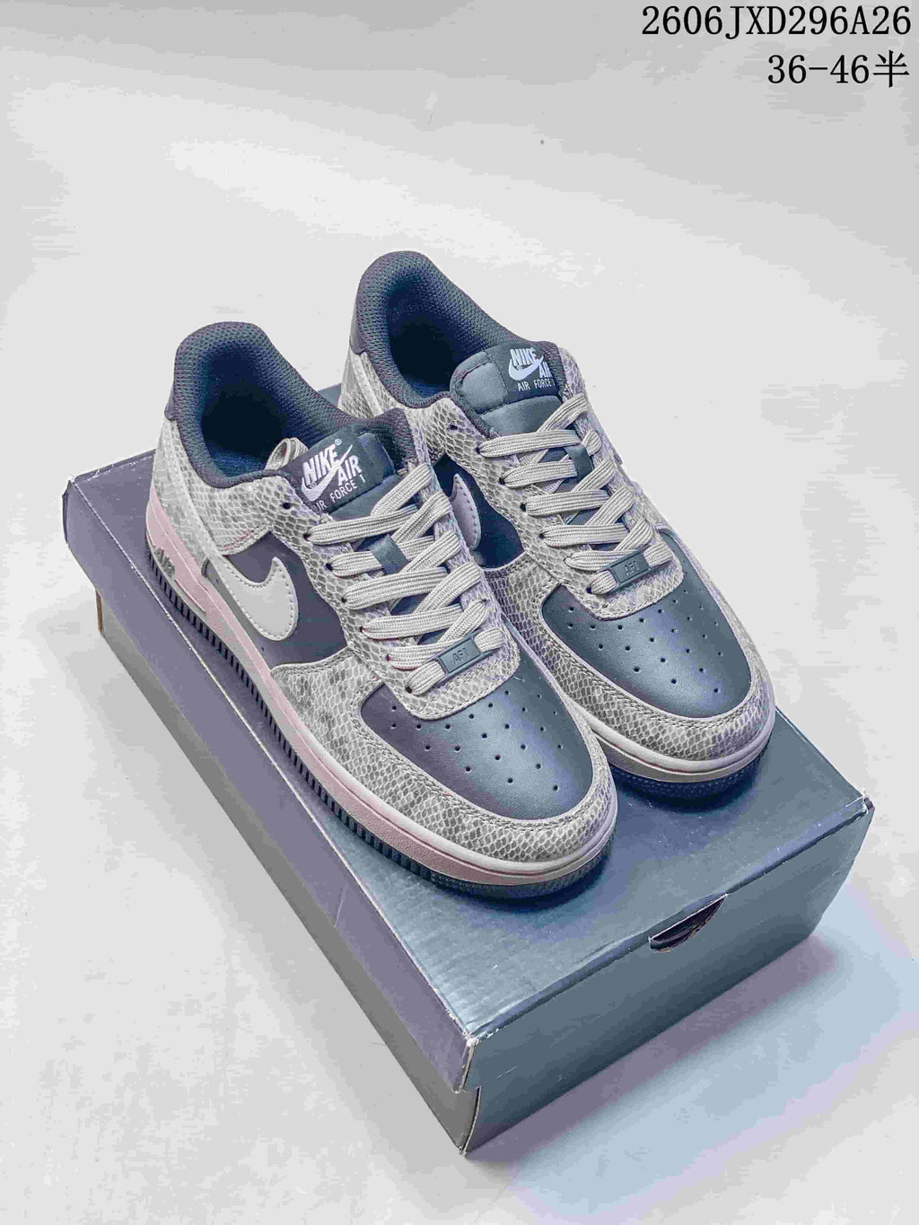 Charcoal Nike Air Force 1 low-top sneakers with patterned overlays and a light Swoosh.
