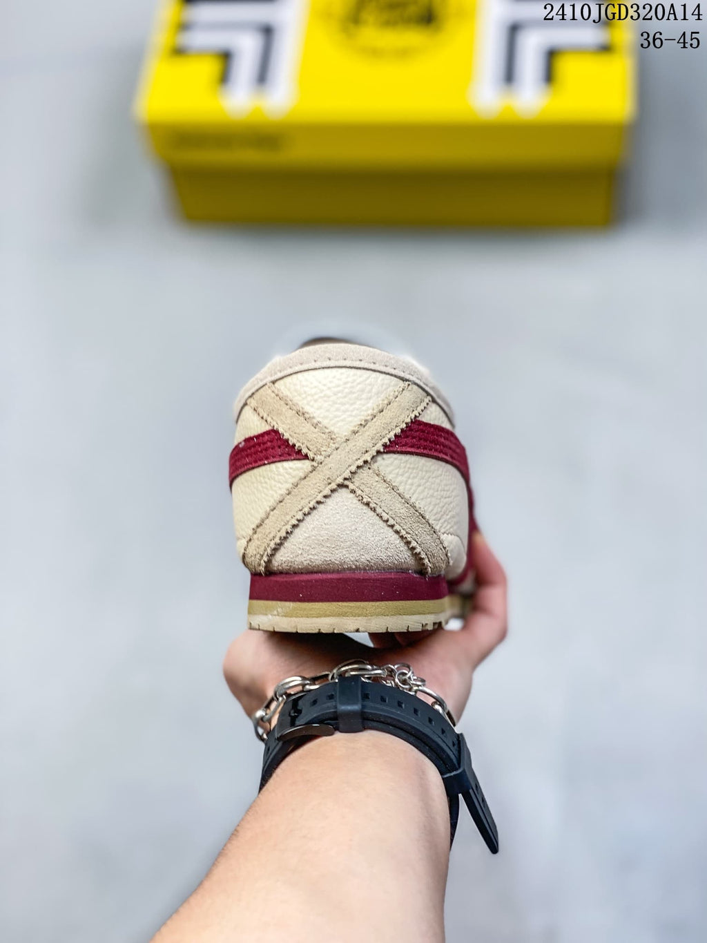 Rear view showing the cream heel with crossed overlay panels, red accents, and a layered heel section.