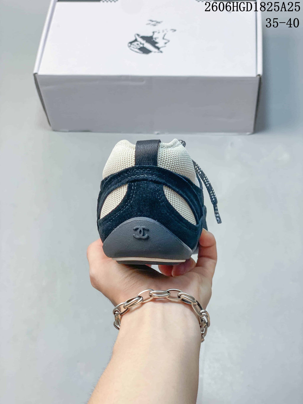 Rear view of a navy and off-white trainer with heel detail