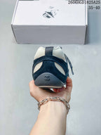 Rear view of a navy and off-white trainer with heel detail
