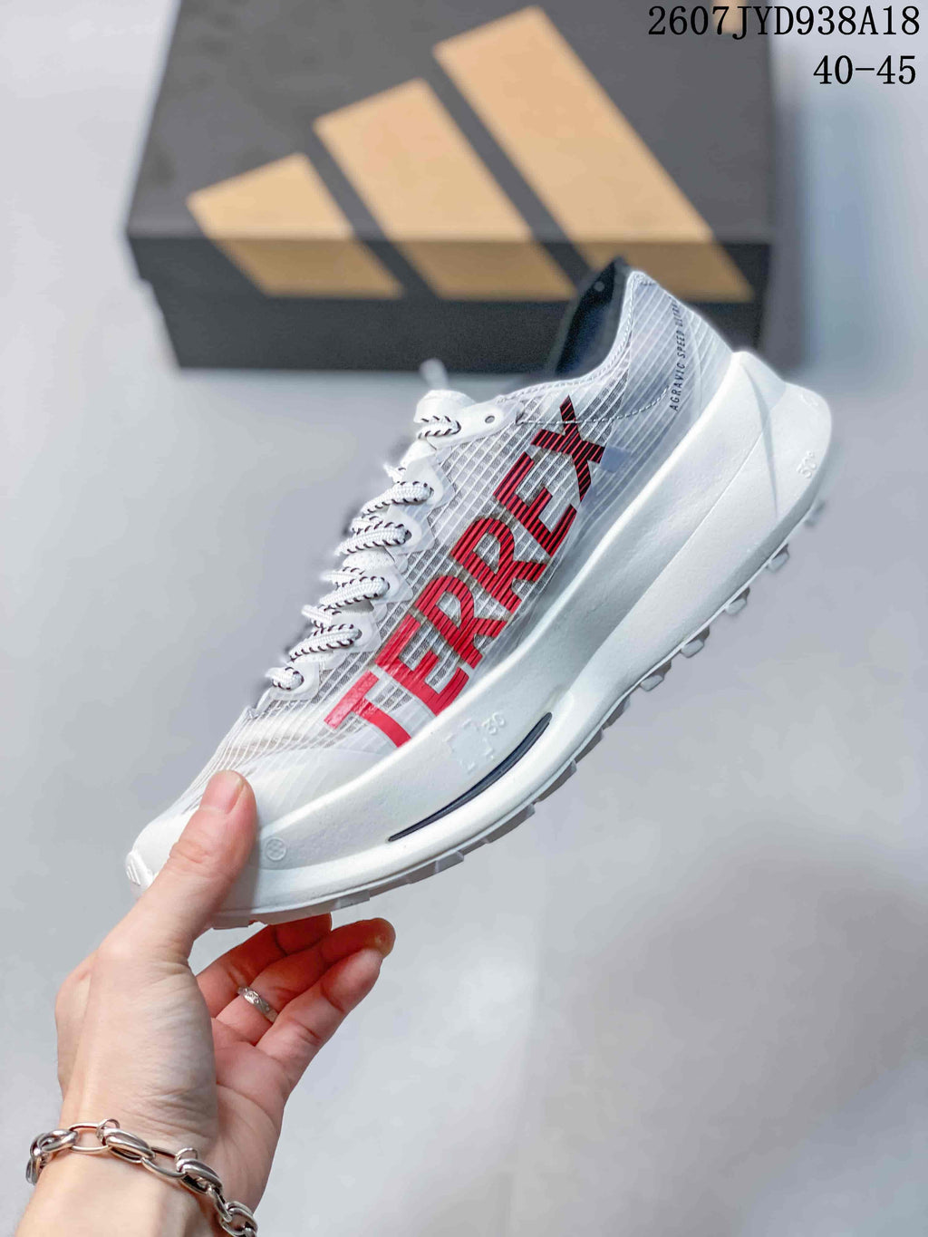 Side profile of the white and red running shoe showing the textile upper, red branding, raised midsole, and outsole.