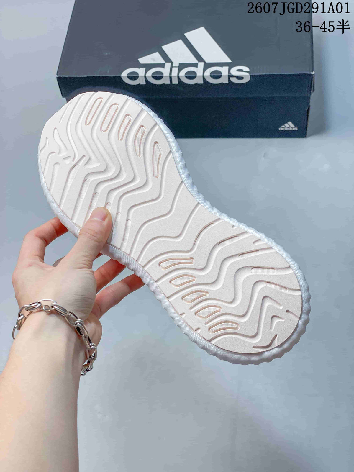 Close-up of the textured outsole on the white and pale pink sneakers