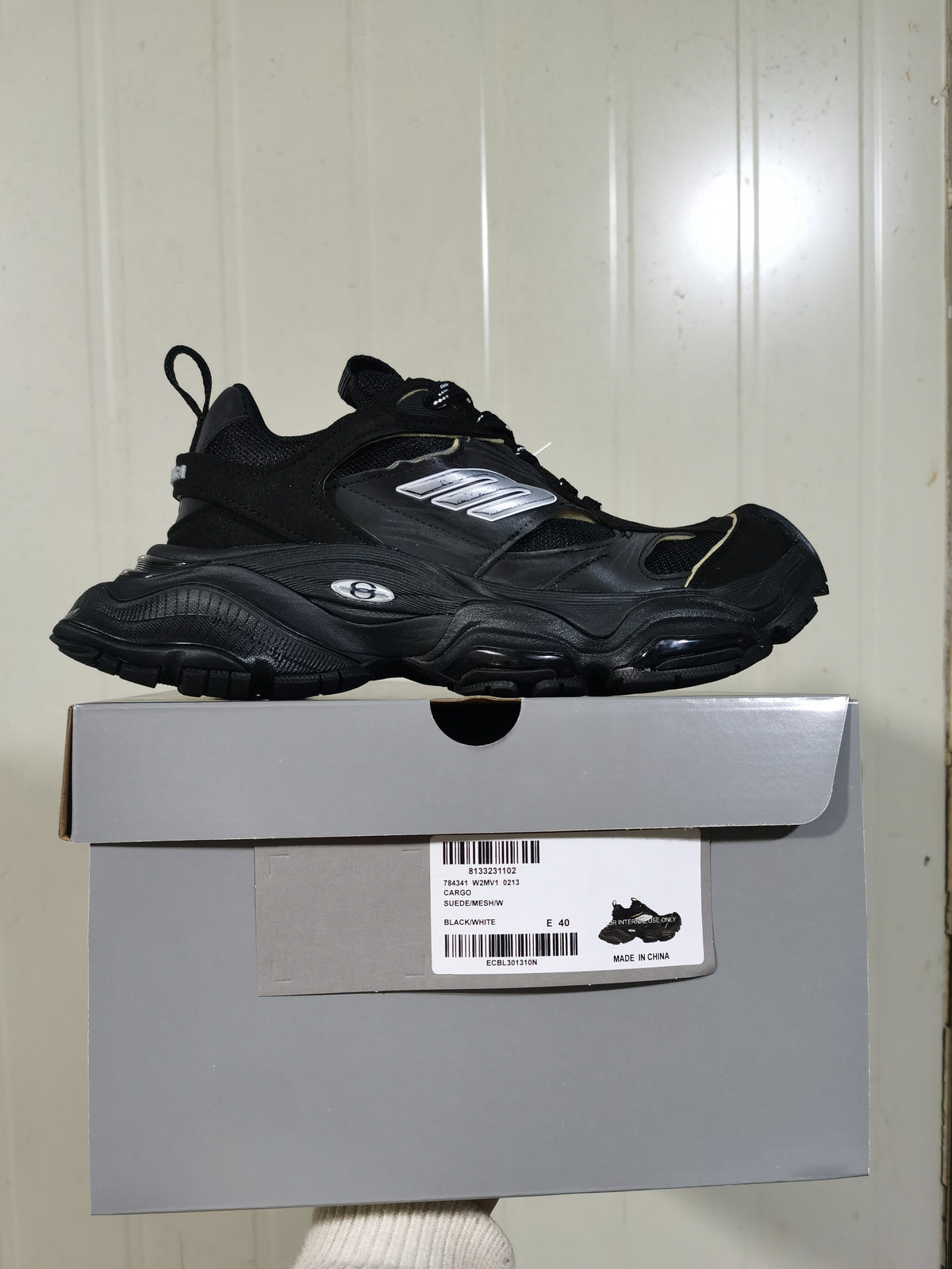 Black and white chunky sneaker displayed on its box; the box label shows style 0213, color BLACK/WHITE, and size E 40.