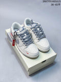 Pair of white and gray Nike low-top sneakers with red accents displayed on a shoebox.