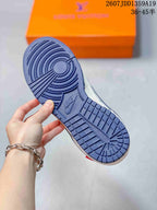 Close-up of the navy rubber outsole showing circular forefoot traction and molded NIKE branding.
