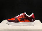 Side view showing the glossy burgundy and orange upper, large star-shaped side detail and white sole.