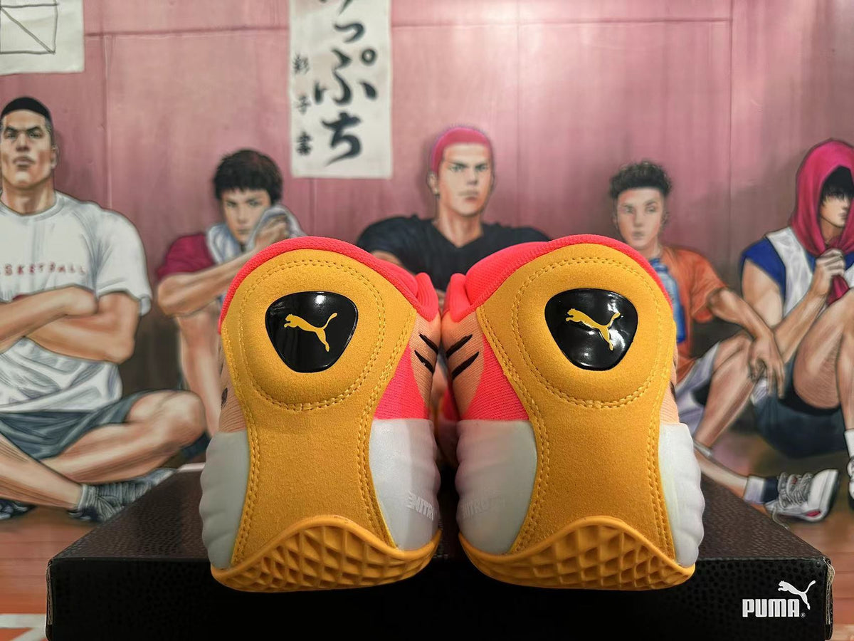 Rear view of pink, gold, and white PUMA All-Pro basketball shoes.