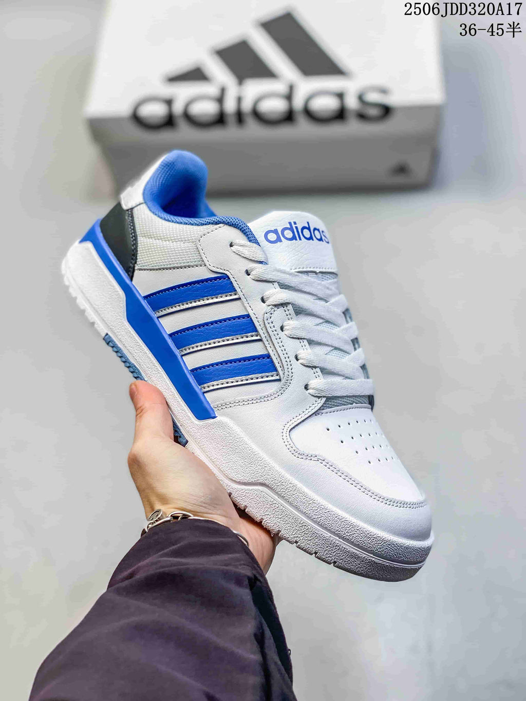 White adidas Entrap sneaker with bright blue side stripes, heel detailing and a dark outsole.