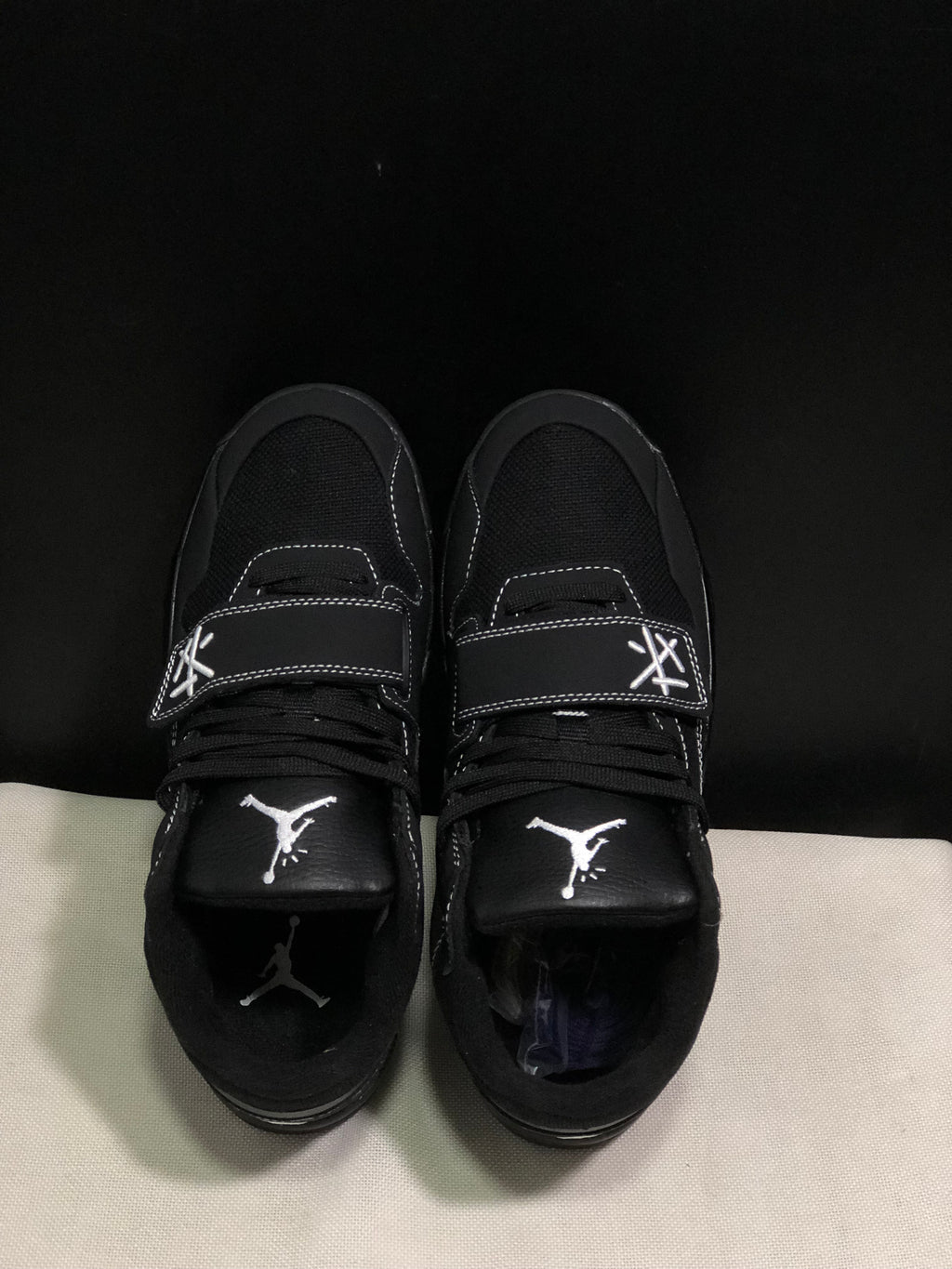 Top view showing the black laces, Jumpman tongue logos and adjustable forefoot straps.
