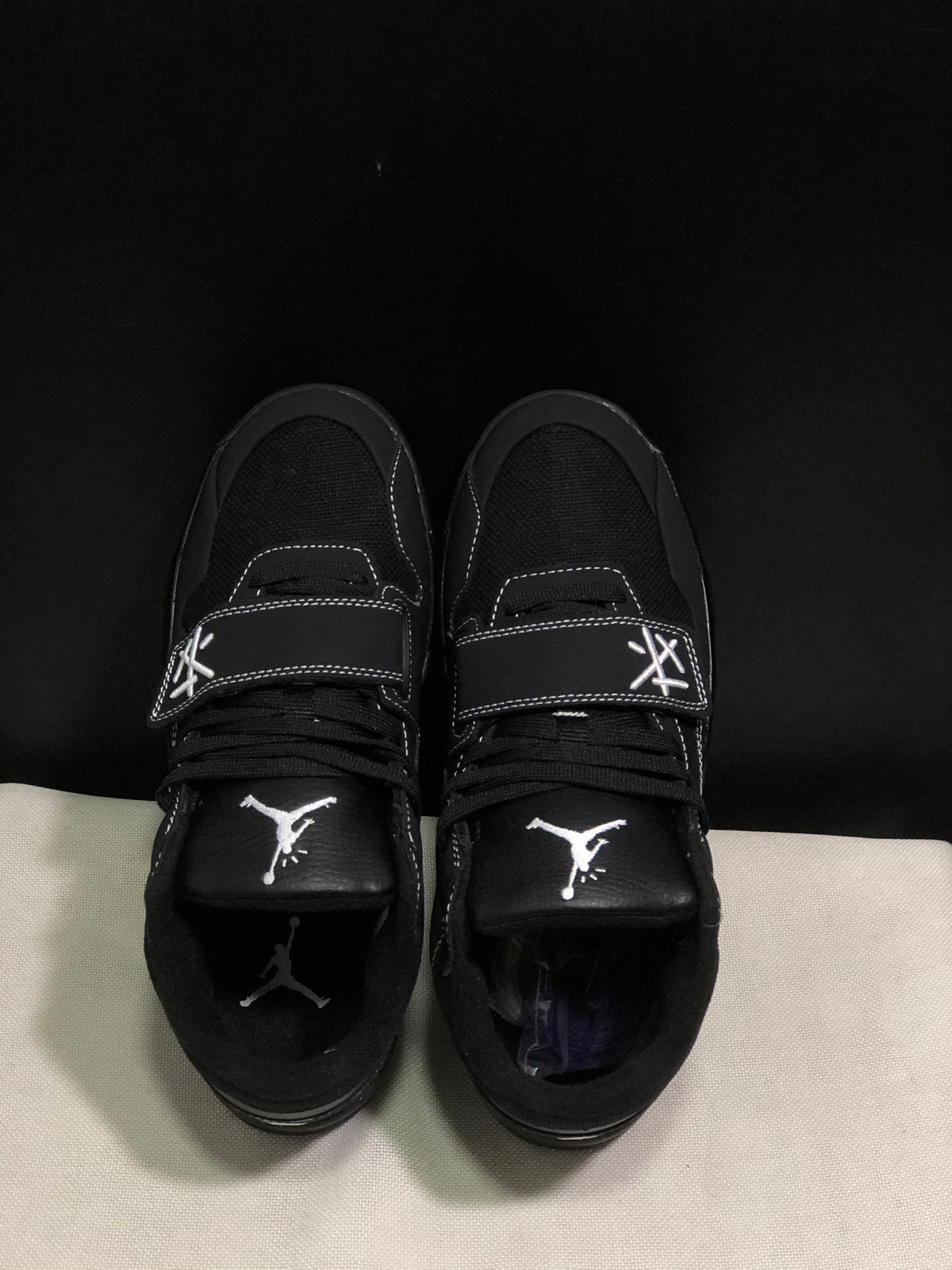 Top view showing the black laces, Jumpman tongue logos and adjustable forefoot straps.