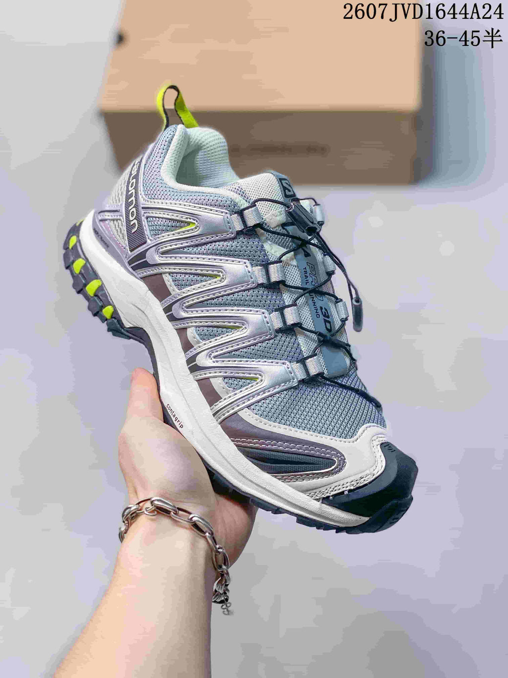 Three-quarter side view of the Salomon XA PRO 3D Seasonal sneaker showing the gray and white upper, dark outsole and neon yellow accents.