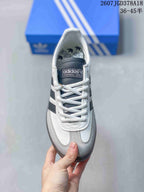 Top view of the sneaker showing white laces, gray toe overlays, and a branded tongue.