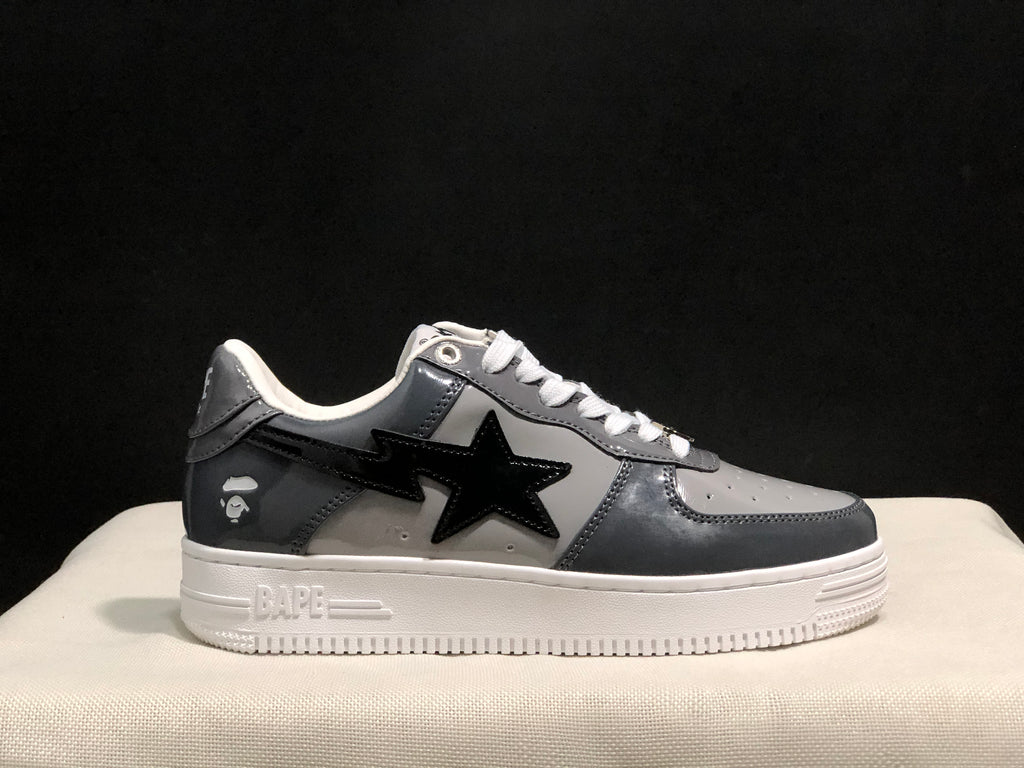 Lateral side profile showing the dark gray upper, black star detail, and embossed BAPE outsole branding.