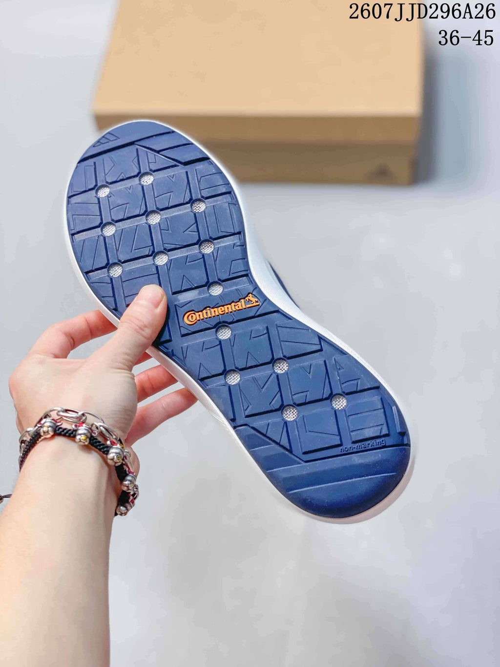 Underside of the navy shoe showing a patterned outsole with Continental branding.