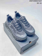 Pair of black DESCENTE TERRAIND low-top sneakers displayed on a branded shoebox.