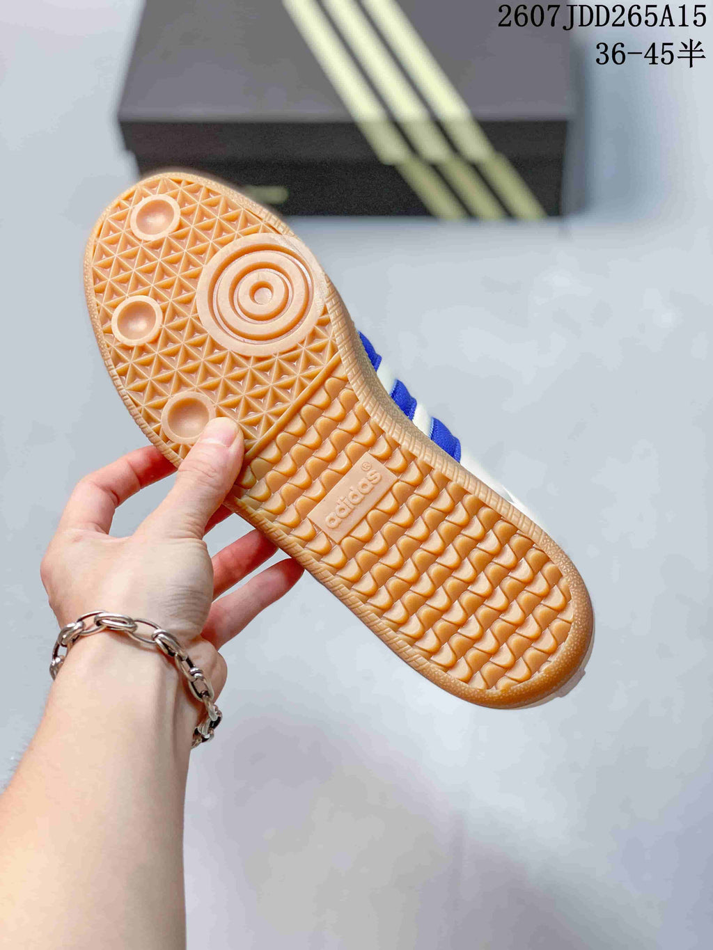 Close-up of the gum-colored outsole with textured traction pattern and adidas branding.