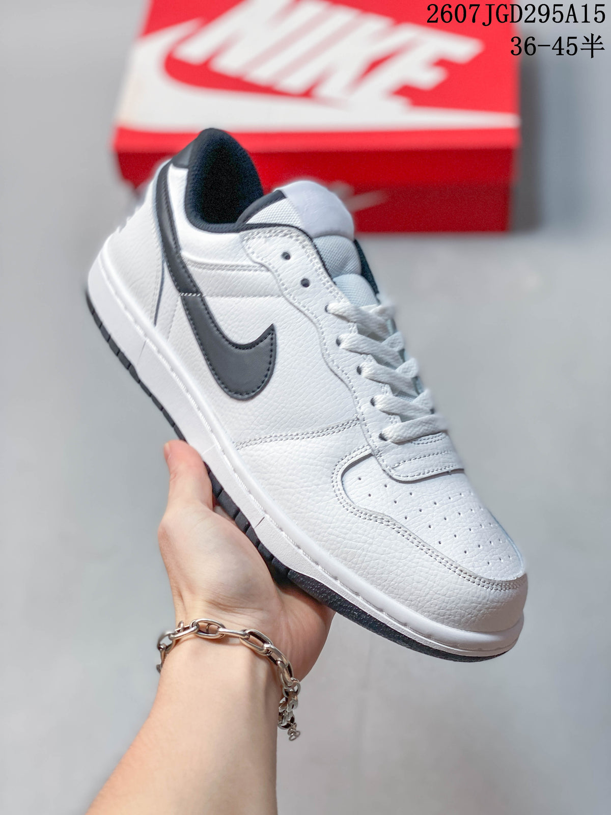 Angled side view showing the white upper, black Swoosh, perforated toe box, white midsole, and black outsole.