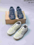 Dark navy and pale ivory ASICS GEL-1130 sneakers shown together.