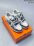 Pair of white and navy low-top sneakers with contrasting rope-style laces displayed on an orange shoe box.