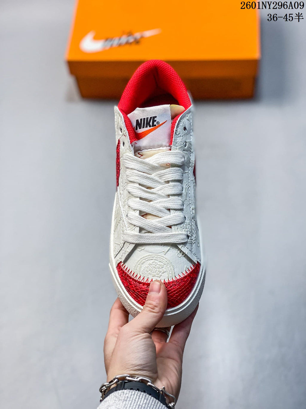 Top view showing white laces, a red padded collar, and red textured toe detailing.