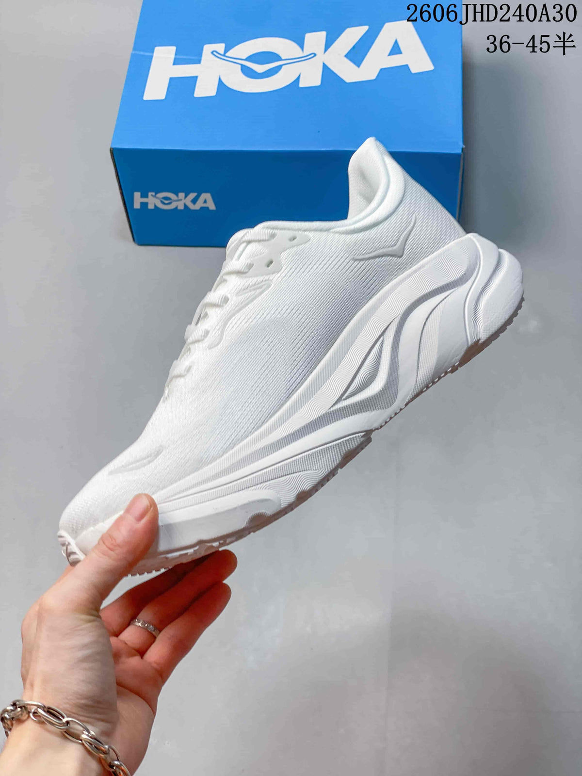 Side view of the white low-top running shoe