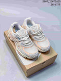 Pair of ASICS GEL-NYC sneakers in white, grey and peach displayed on a shoebox; size range text is visible above.