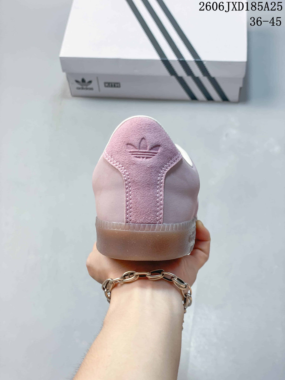 Rear view of the pink sneaker showing its heel panel and translucent sole.