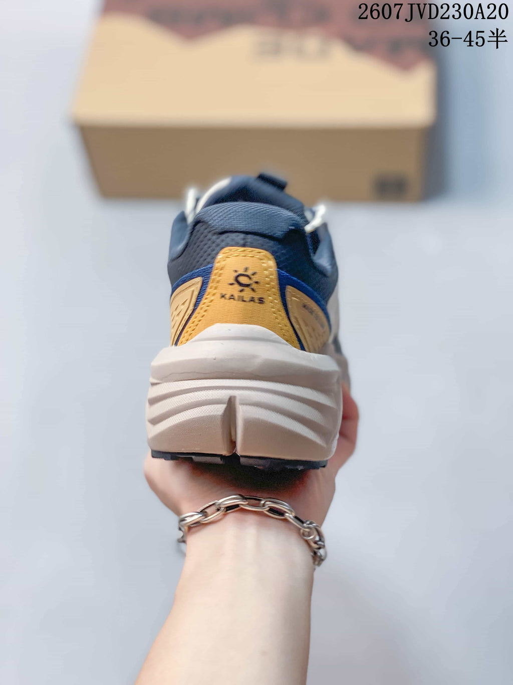 Rear view showing the KAILAS heel label, padded collar, layered heel structure, and textured midsole.