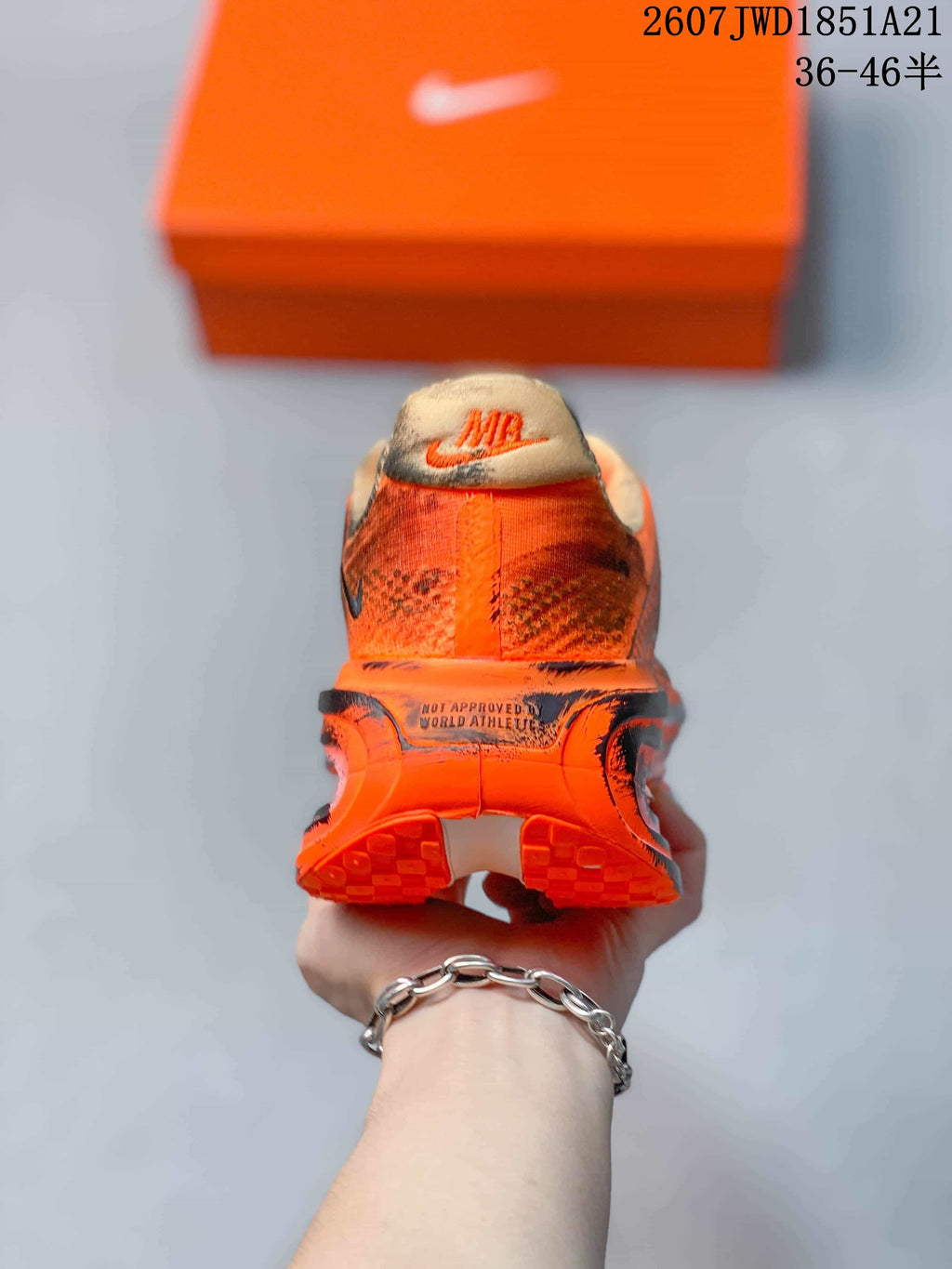 Rear view showing the heel branding, padded collars and orange outsole.