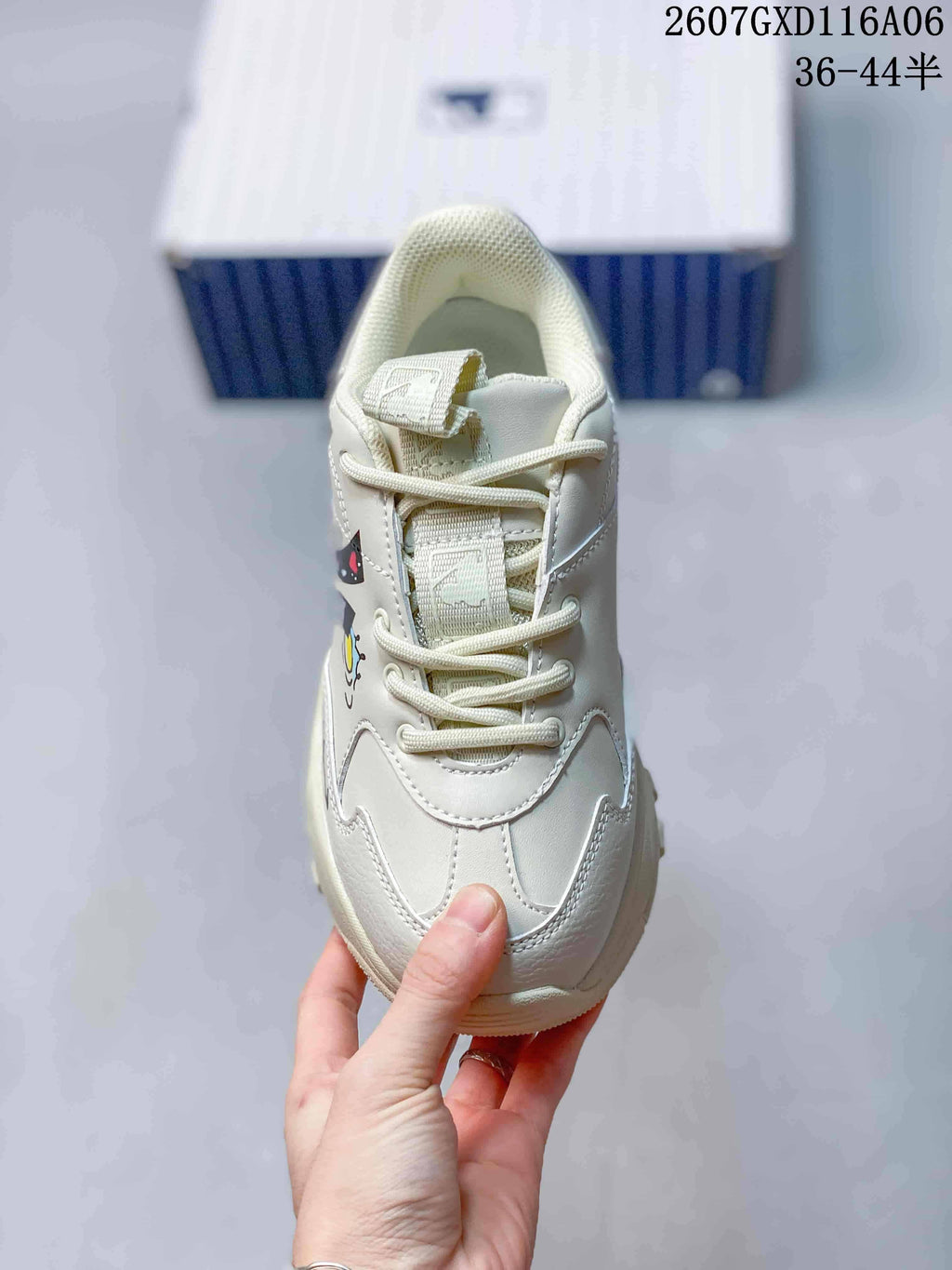 Top view of the sneaker showing the lace-up closure, padded tongue and cream beige upper.