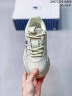Top view of the sneaker showing the lace-up closure, padded tongue and cream beige upper.