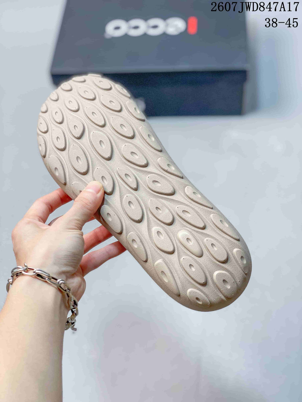 Close-up of the light-colored outsole showing raised oval tread elements.